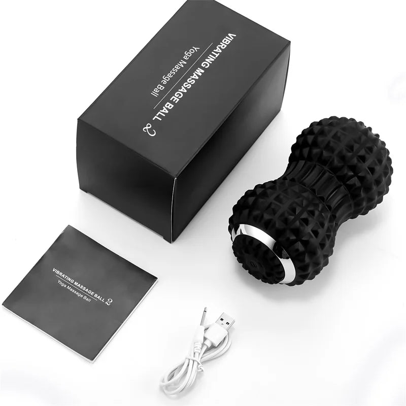 Motyx vibrating massage ball with textured black design, charging cable, manual, and box