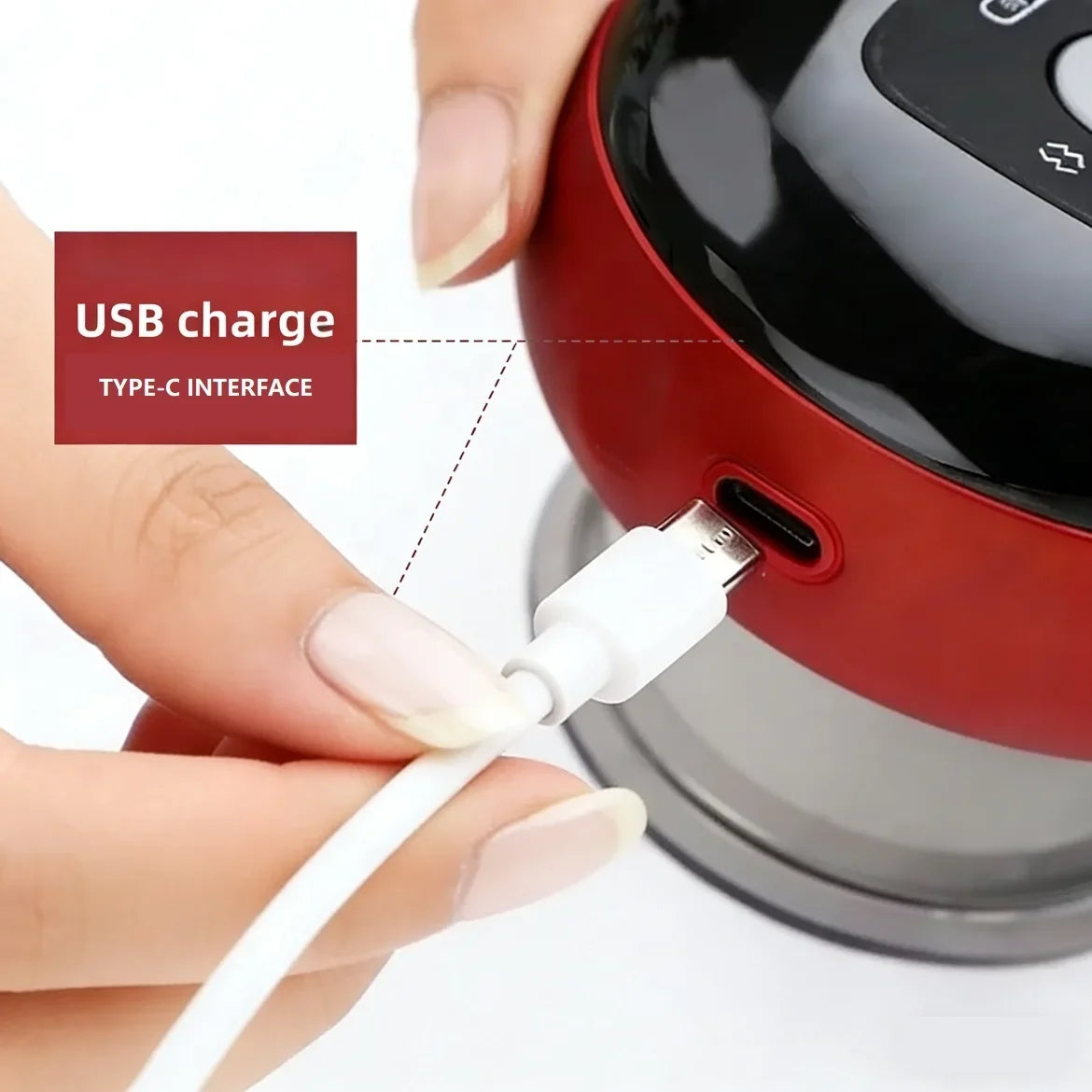 Hand plugging USB Type-C cable into red Motyx device for charging